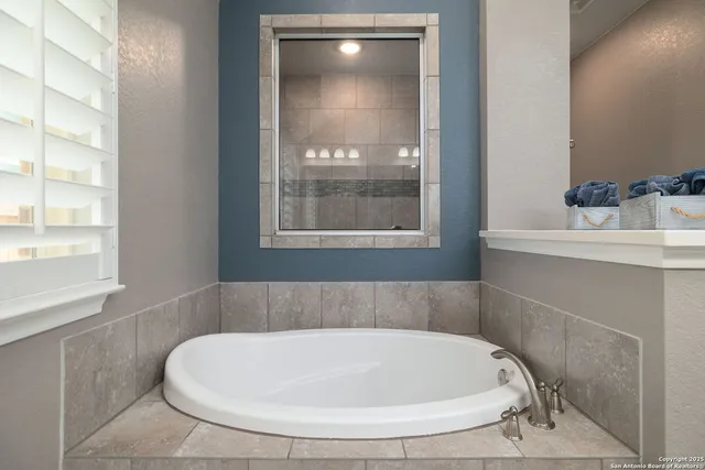 a bathroom with a granite countertop sink a toilet and shower
