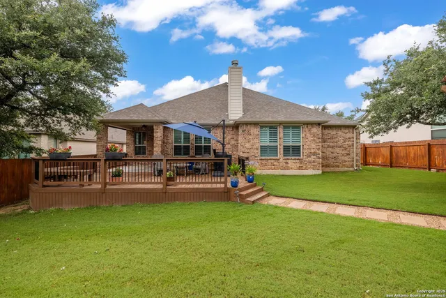 a view of a house with backyard porch and sitting area