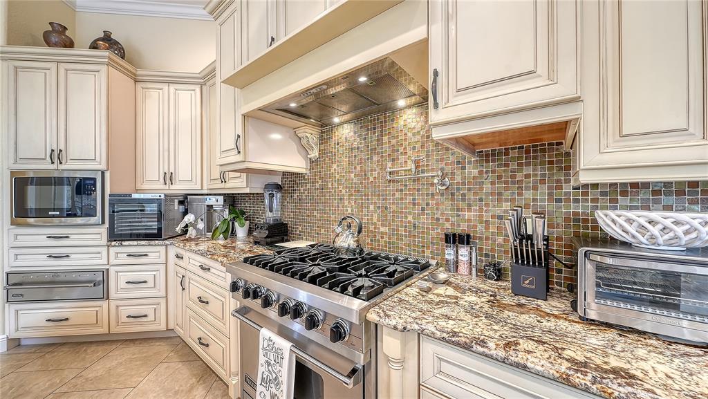 1630 Assisi Drive, Unit 18 Sarasota, FL 34231 - Photo 12 of 42 a kitchen with stainless steel appliances granite countertop a stove and a cabinets