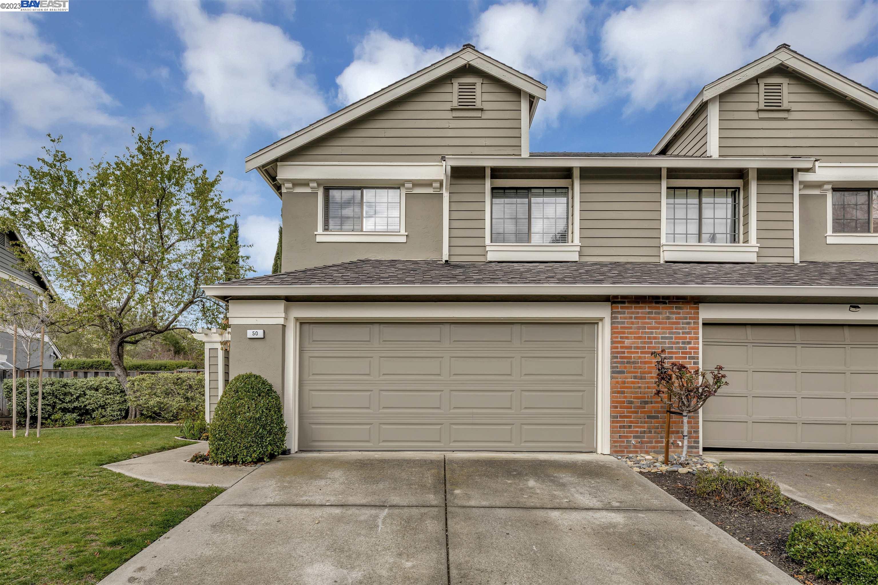 a view of a house with a yard and garage