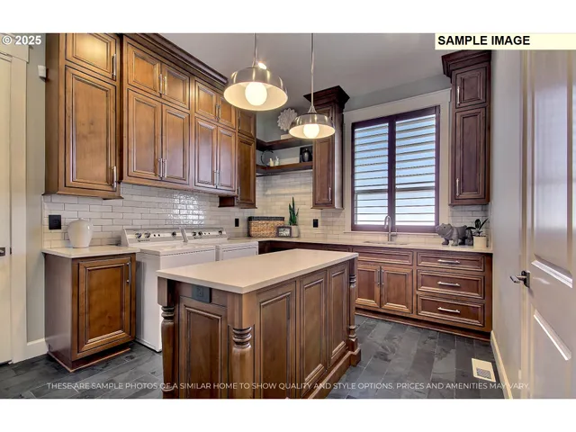 a kitchen with kitchen island granite countertop a sink cabinets and stainless steel appliances