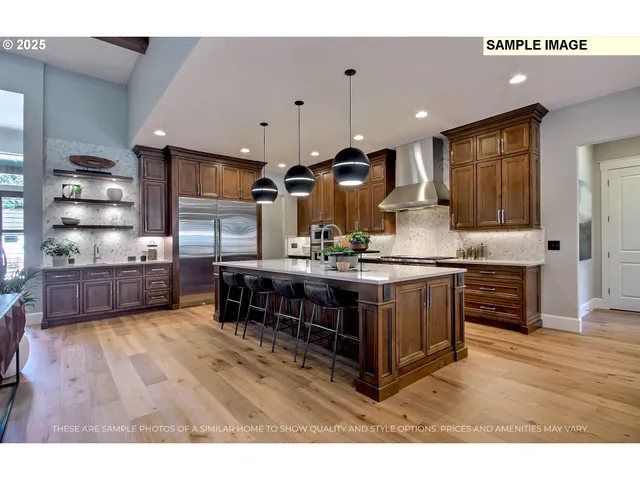 a kitchen with stainless steel appliances kitchen island granite countertop a stove a sink and a refrigerator