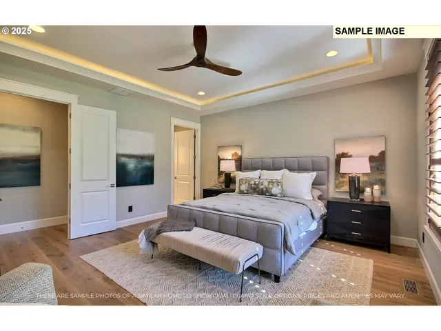 a spacious bedroom with a bed and a flat screen tv