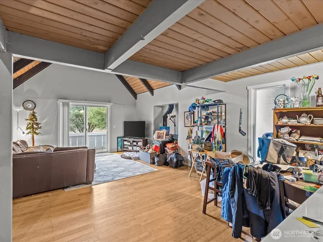 a view of a livingroom with workspace and a window