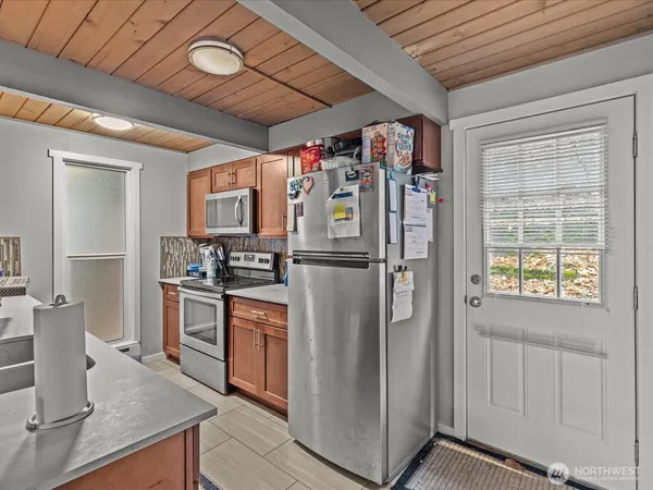 a kitchen with stainless steel appliances granite countertop a refrigerator and a stove