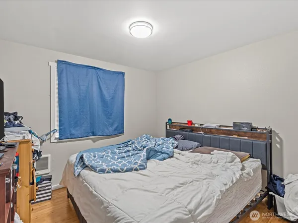 a bedroom with a bed and a dresser