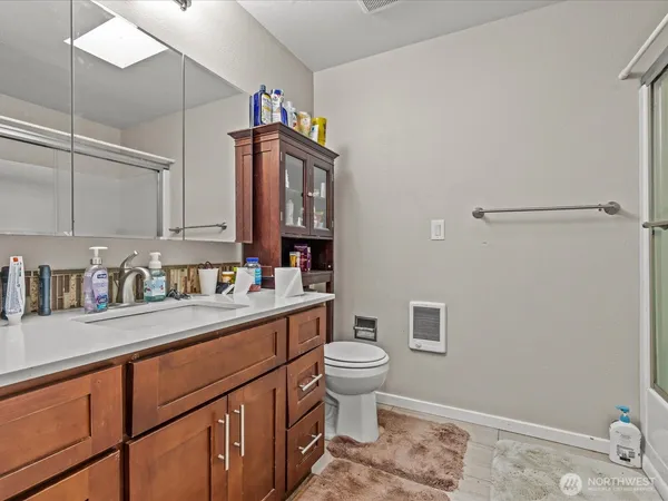 a kitchen with stainless steel appliances a sink cabinets and wooden floor