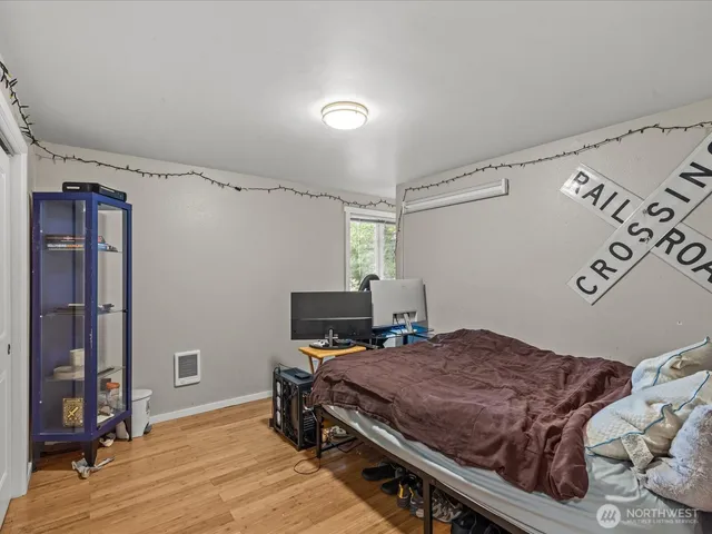 a bedroom with a bed and a desk