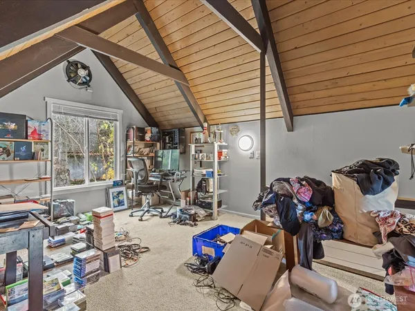a bedroom with furniture and a flat screen tv