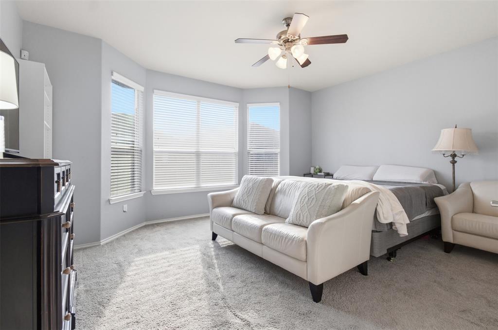10928 Middleglen Road Fort Worth, TX 76052 - Photo 17 of 37 a bed room with a bed couch and a ceiling fan