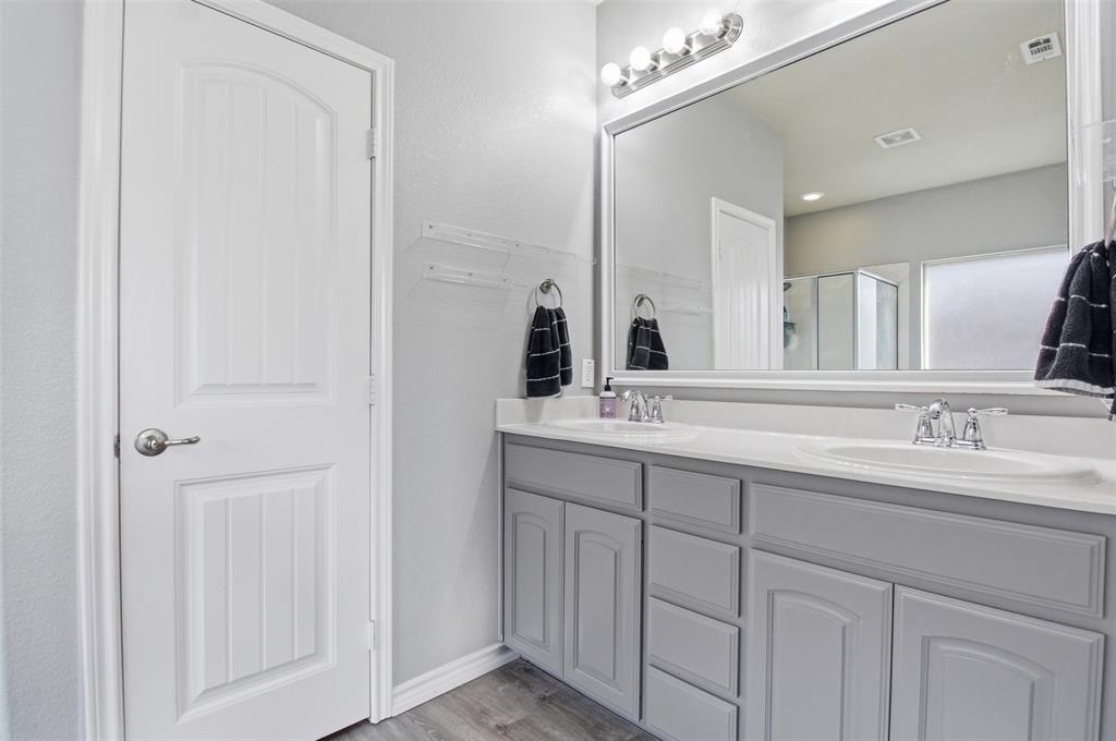 10928 Middleglen Road Fort Worth, TX 76052 - Photo 20 of 37 a bathroom with a double vanity sink and a mirror