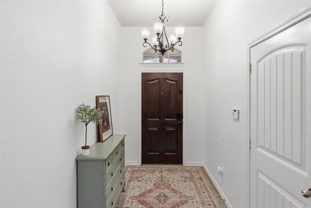 10928 Middleglen Road Fort Worth, TX 76052 - Photo 2 of 37 a view of a hallway with a chandelier