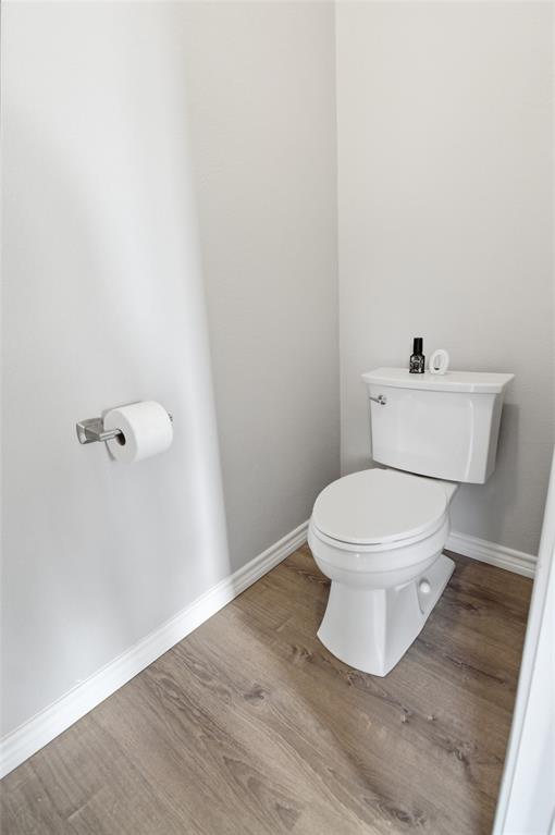 10928 Middleglen Road Fort Worth, TX 76052 - Photo 21 of 37 a white toilet sitting next to a white wall