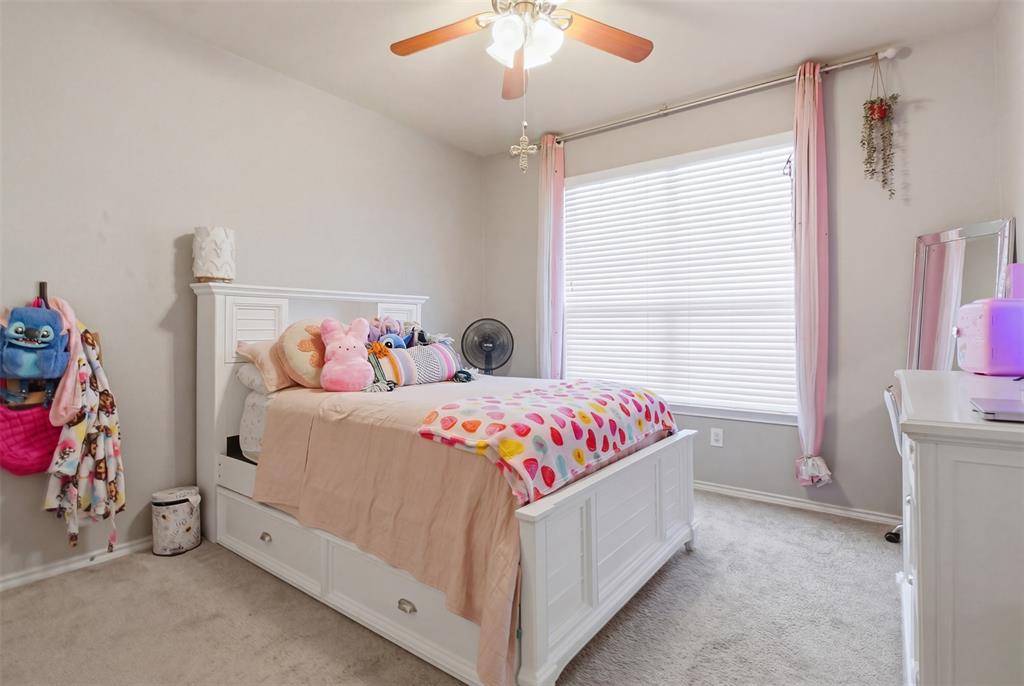 10928 Middleglen Road Fort Worth, TX 76052 - Photo 23 of 37 a bedroom with a bed and a chandelier