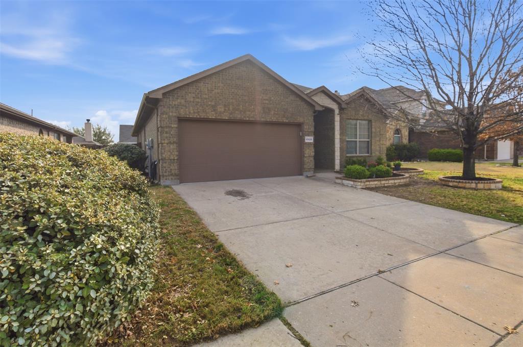10928 Middleglen Road Fort Worth, TX 76052 - Photo 36 of 37 a front view of a house with a garden