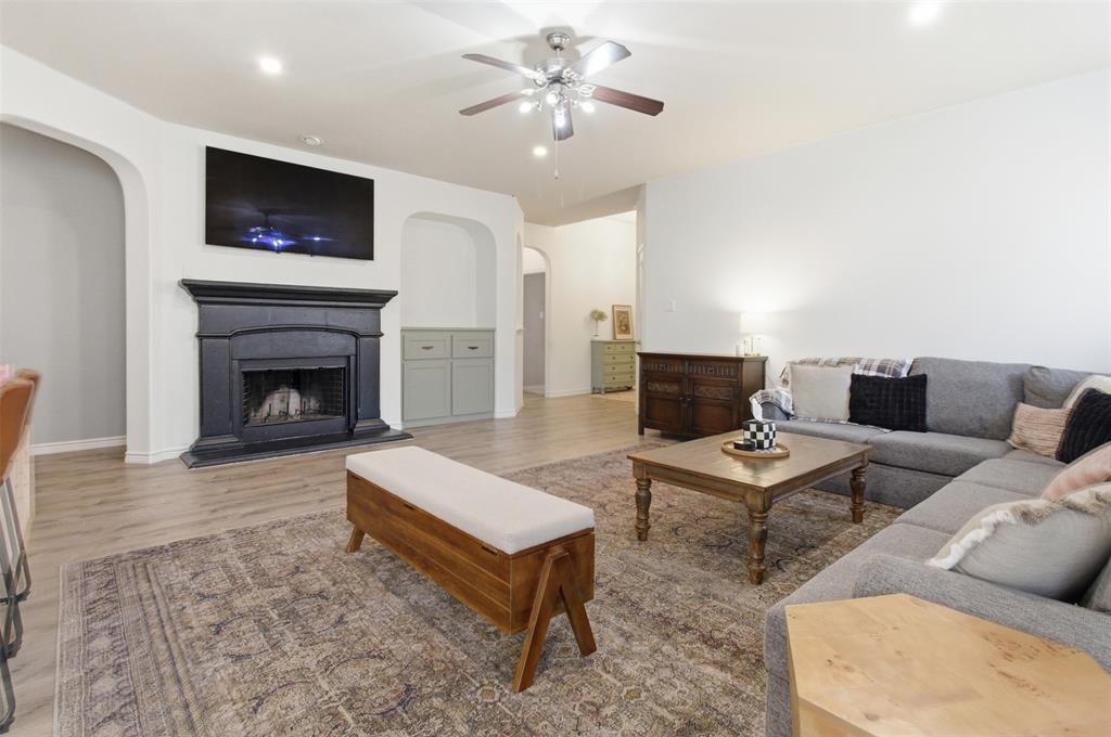 10928 Middleglen Road Fort Worth, TX 76052 - Photo 9 of 37 a living room with furniture a flat screen tv and a fireplace