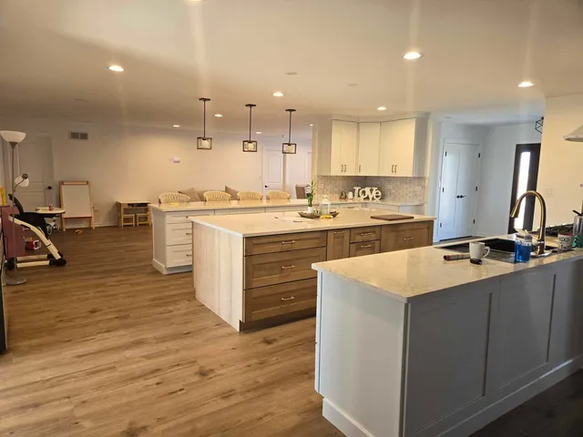 a kitchen with a sink appliances and cabinets