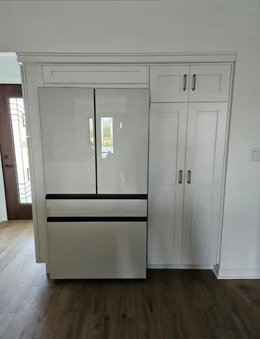 a view of a hallway with wooden floor