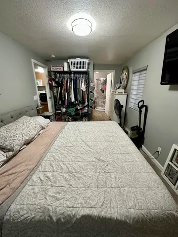 a bed room with a bed mirror and a chair