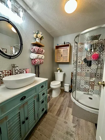 a bathroom with a sink mirror and toilet