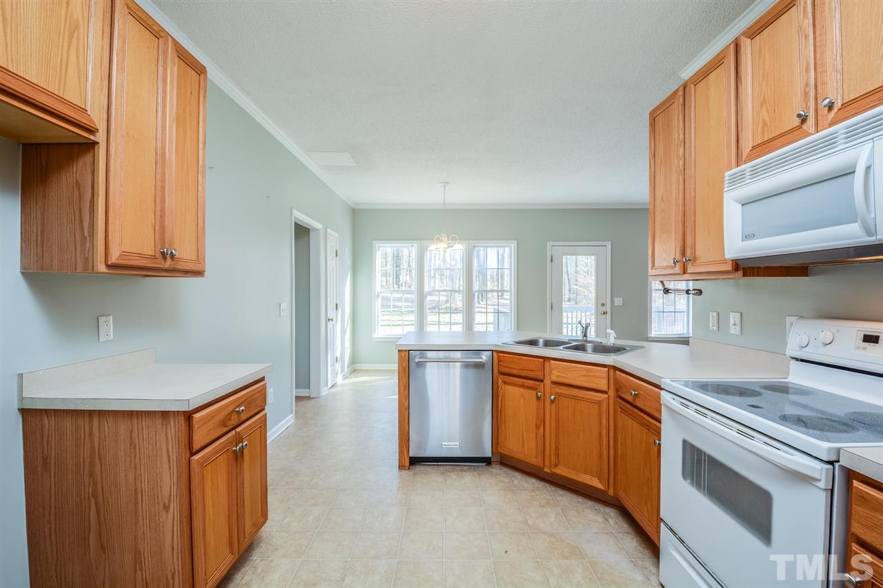 8413 Ridgebury Road Raleigh, NC 27603 - Photo 2 of 18 a kitchen with a sink stove and cabinets