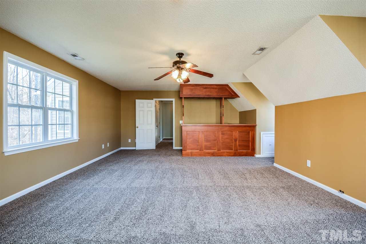 8413 Ridgebury Road Raleigh, NC 27603 - Photo 11 of 18 a view of a room with a chandelier fan and windows