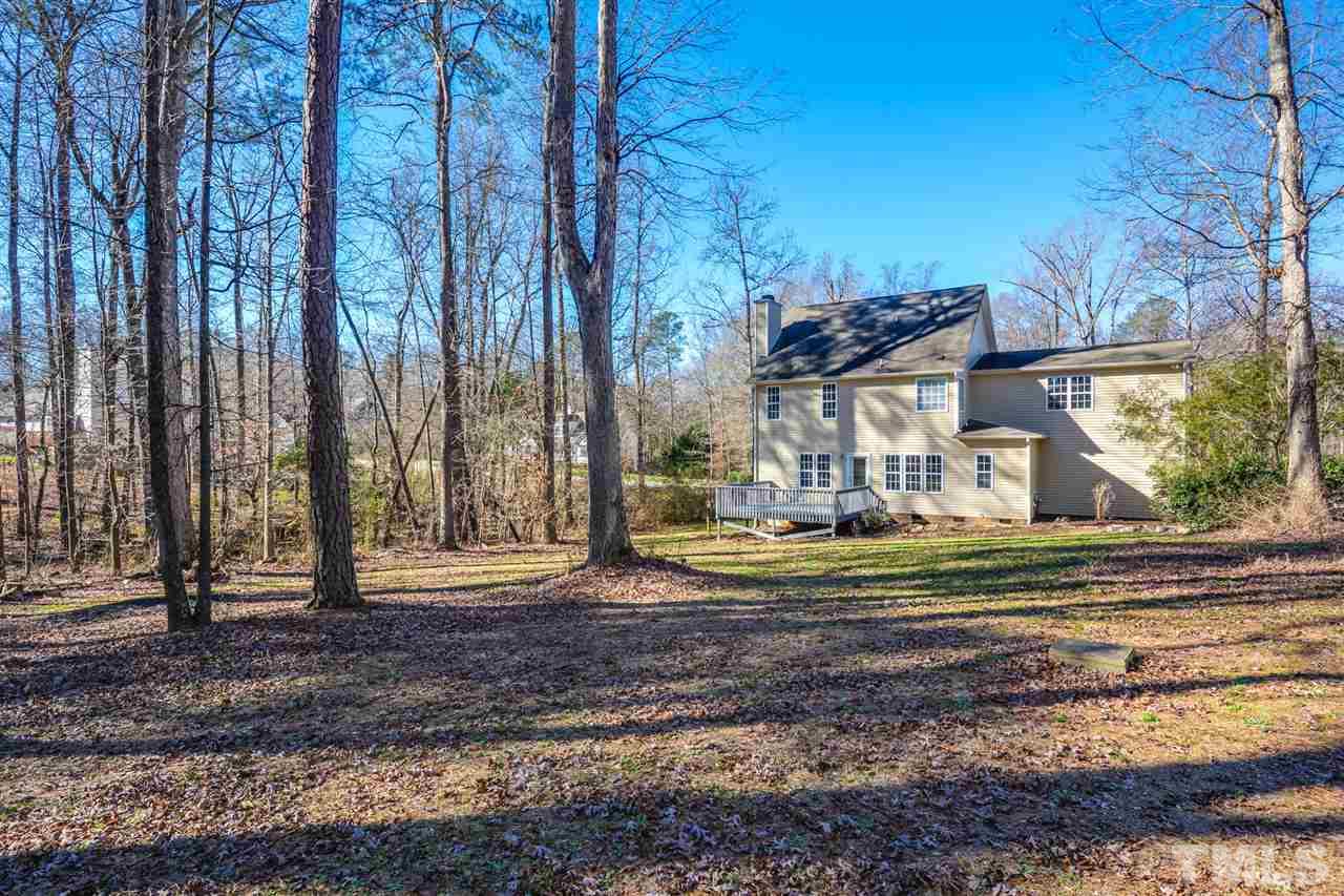 8413 Ridgebury Road Raleigh, NC 27603 - Photo 18 of 18 a view of a house with a yard and large trees