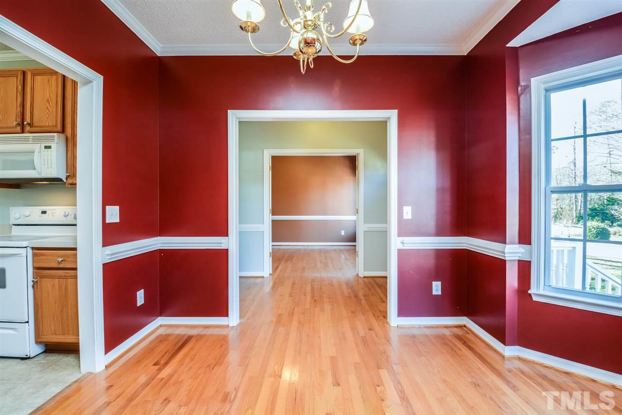 8413 Ridgebury Road Raleigh, NC 27603 - Photo 9 of 18 a view of an empty room with a window and wooden floor