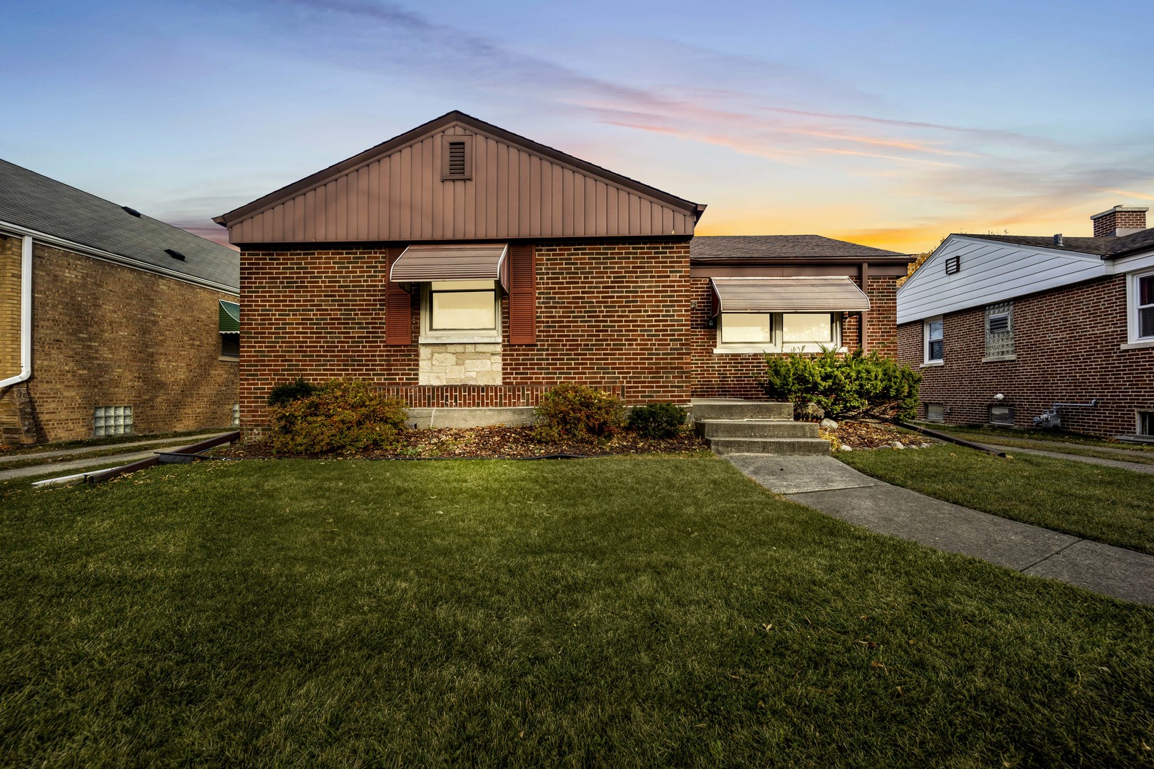 a front view of a house with a garden