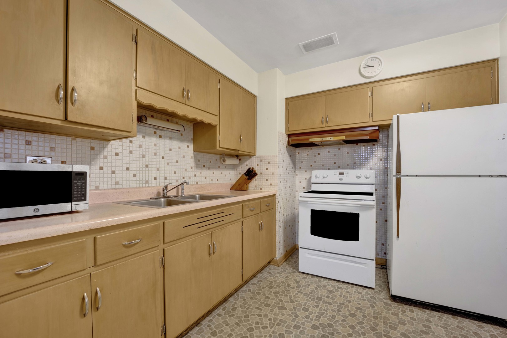2223 South 7th Avenue North Riverside, IL 60546 - Photo 7 of 20 a kitchen with stainless steel appliances a stove a sink and a refrigerator
