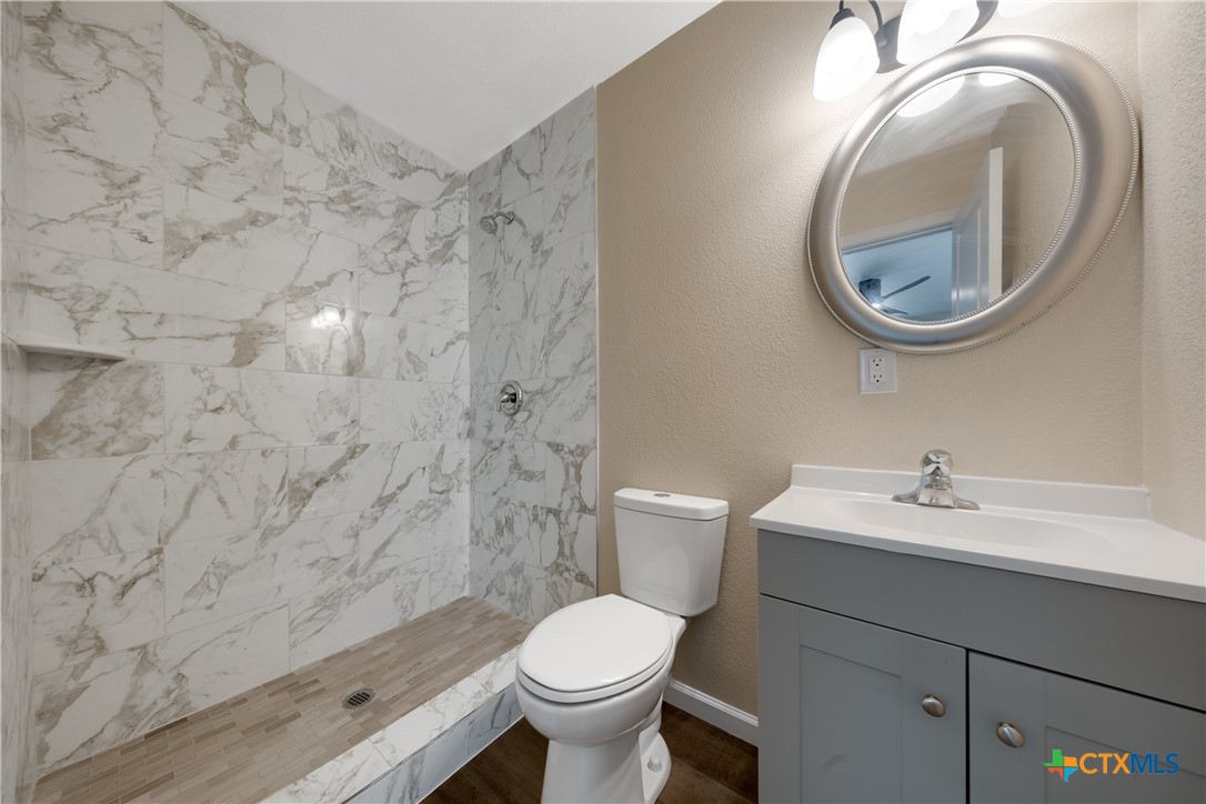 1200 Stephen Street Killeen, TX 76549 - Photo 13 of 22 a bathroom with a sink a toilet and a mirror