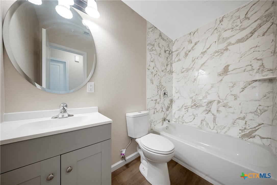 1200 Stephen Street Killeen, TX 76549 - Photo 16 of 22 a bathroom with a toilet sink and mirror