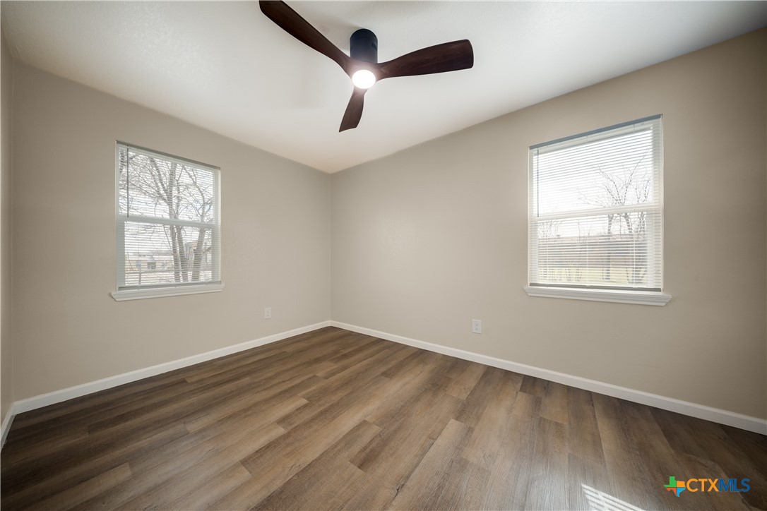 1200 Stephen Street Killeen, TX 76549 - Photo 18 of 22 a view of an empty room with wooden floor and a window