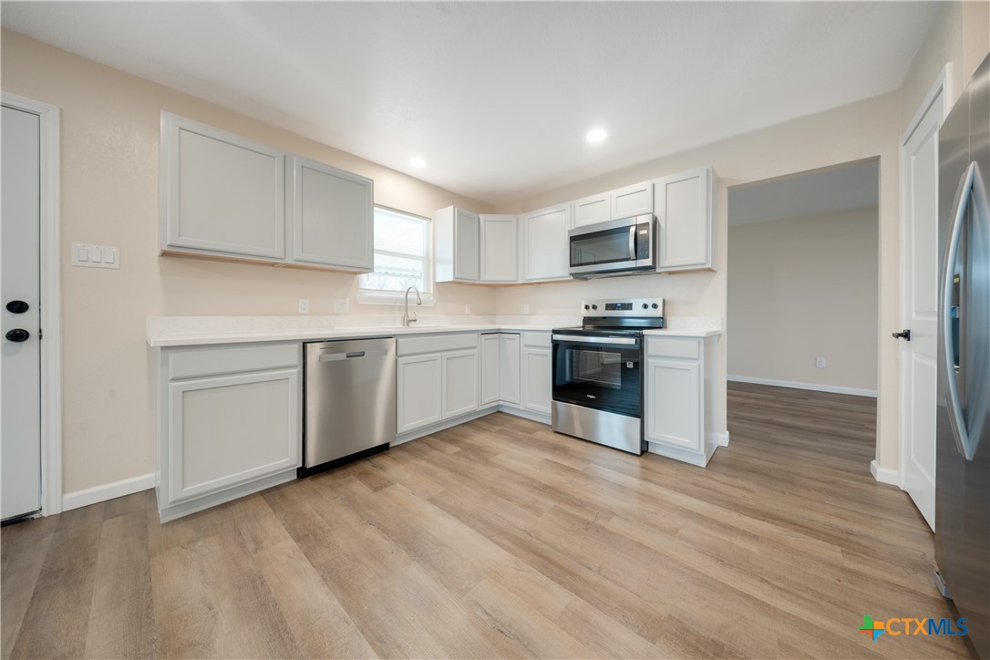 1200 Stephen Street Killeen, TX 76549 - Photo 5 of 22 a kitchen with a stove a sink and a refrigerator