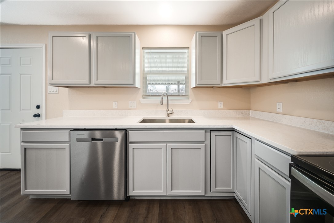 1200 Stephen Street Killeen, TX 76549 - Photo 6 of 22 a kitchen with white cabinets and white appliances