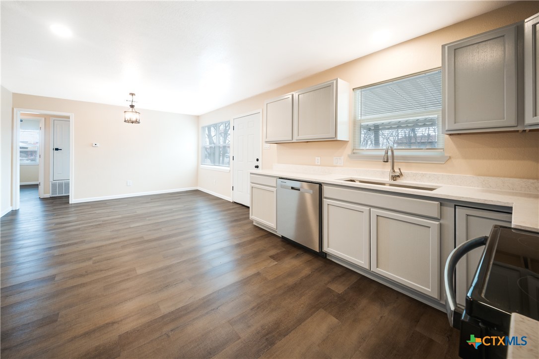 1200 Stephen Street Killeen, TX 76549 - Photo 7 of 22 a kitchen with a sink cabinets and wooden floor