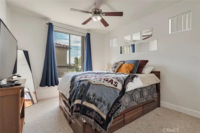 a bedroom with a bed a flat screen tv and a telescope