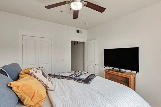 a bedroom with a bed and a flat screen tv