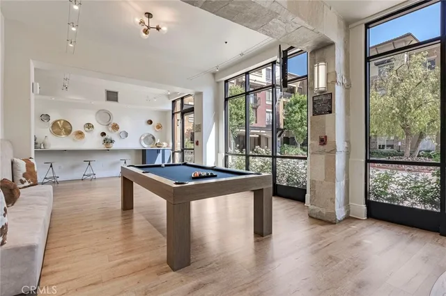 a kitchen with wooden floor and a large window