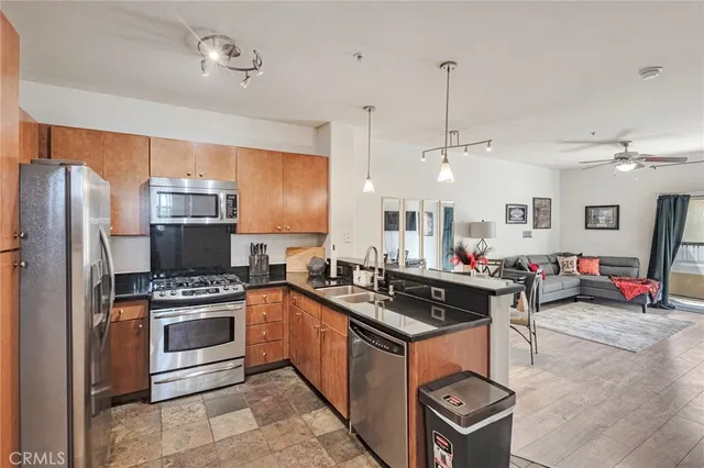 a kitchen with kitchen island a stove a sink and refrigerator
