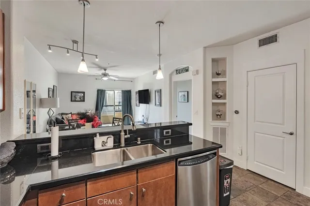 a kitchen with stainless steel appliances granite countertop a sink and a stove