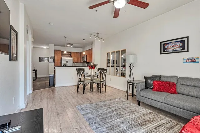 a living room with furniture and kitchen view