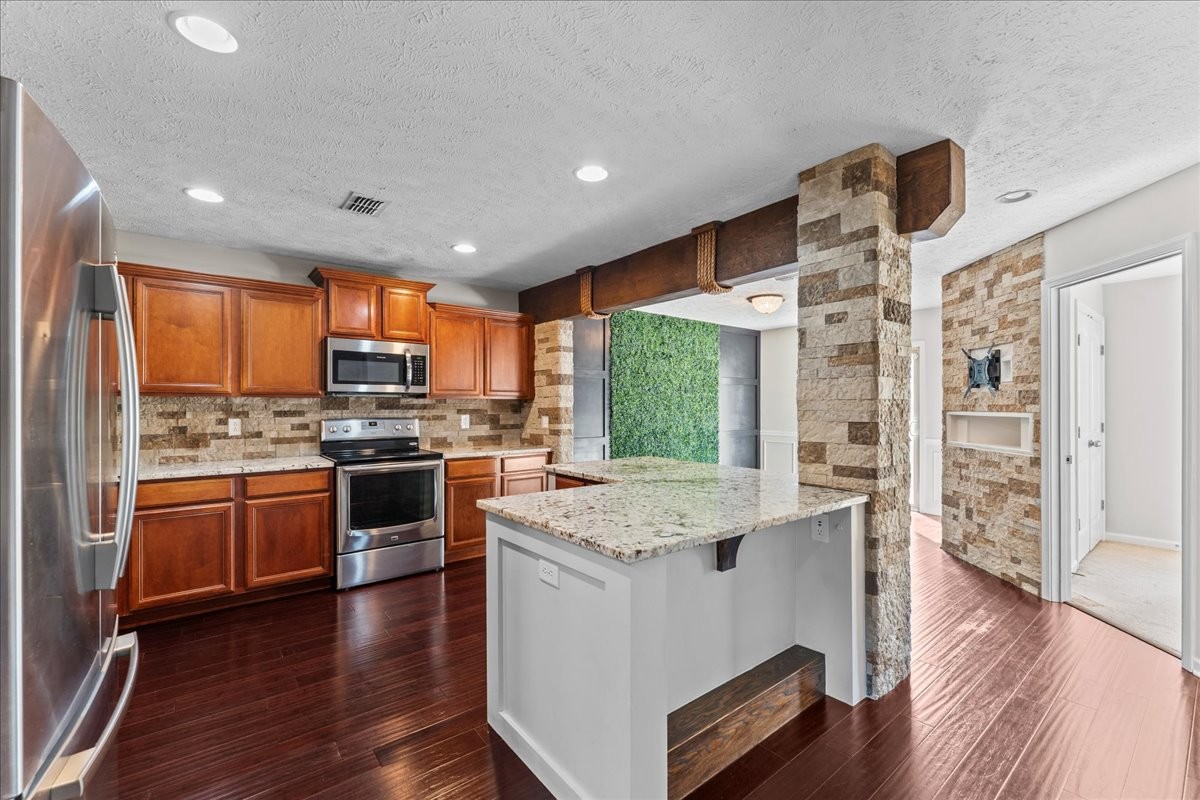 905 Thunder Gulch Way Murfreesboro, TN 37128 - Photo 7 of 27 a kitchen with stainless steel appliances granite countertop a refrigerator a stove top oven a sink dishwasher and wooden floor