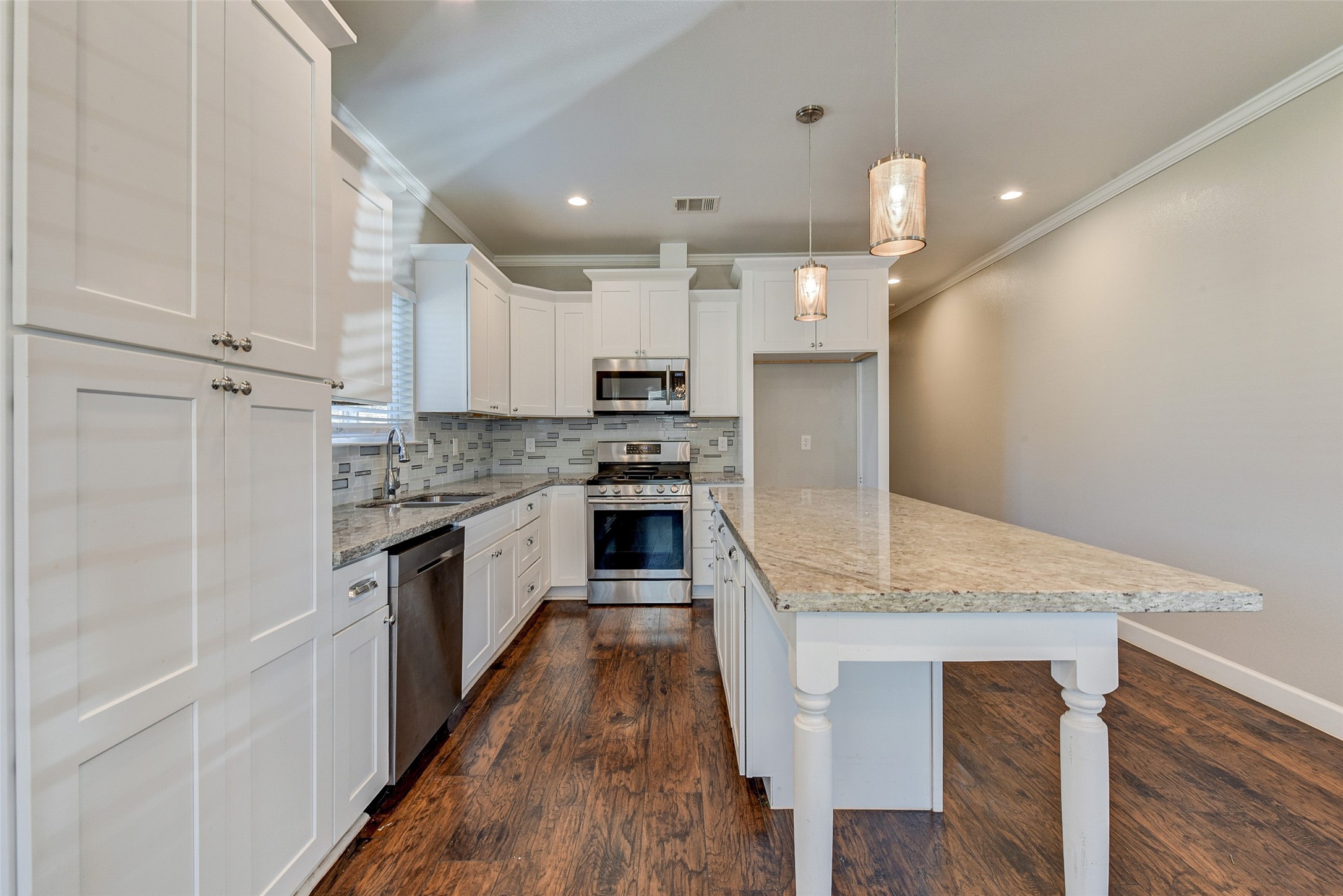 8617 Dosia Street Houston, TX 77051 - Photo 5 of 20 a large kitchen with stainless steel appliances kitchen island granite countertop a stove a sink and a refrigerator