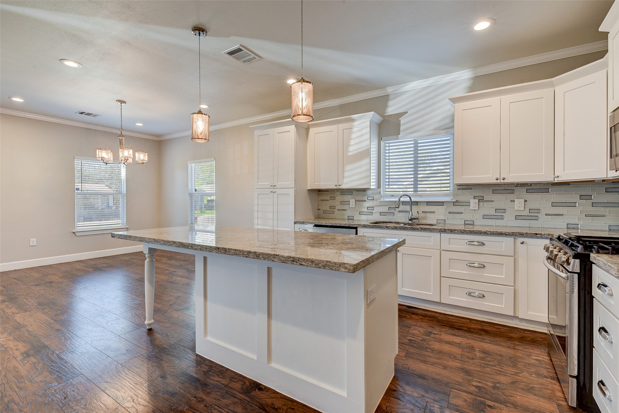 8617 Dosia Street Houston, TX 77051 - Photo 7 of 20 a large kitchen with cabinets wooden floor and a sink