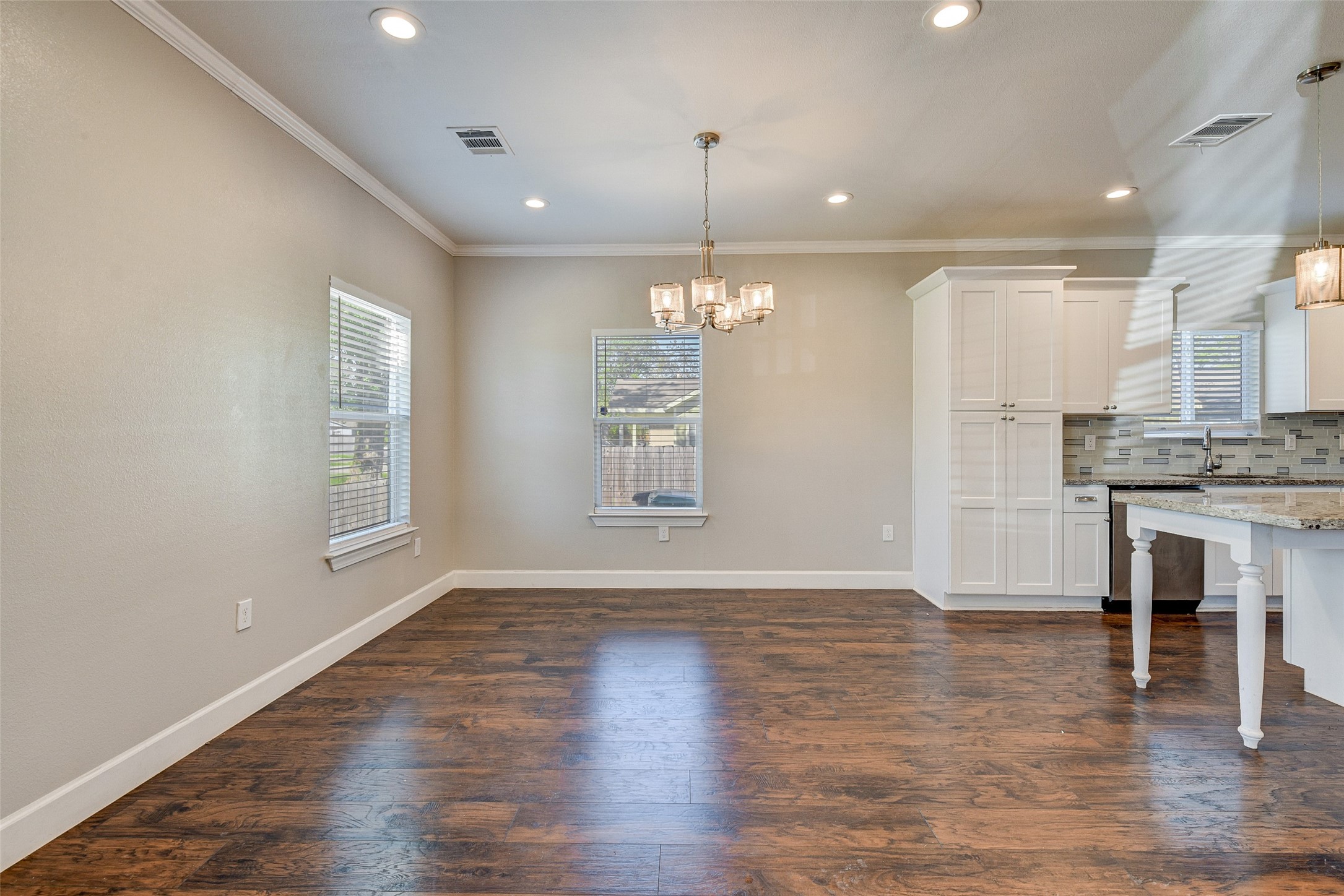 8617 Dosia Street Houston, TX 77051 - Photo 9 of 20 a view of an empty room with wooden floor and a kitchen