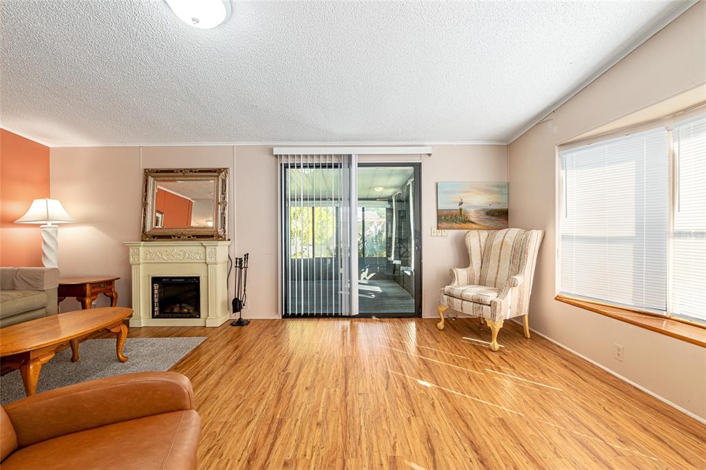 10085 Southeast 126th Place Belleview, FL 34420 - Photo 11 of 45 a living room with furniture and a fireplace