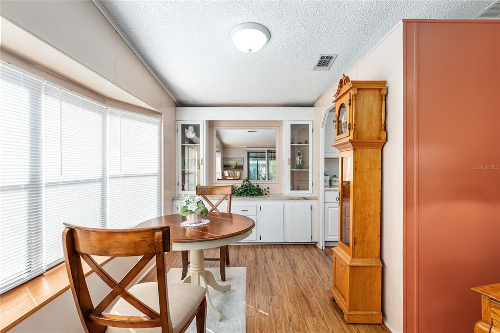 10085 Southeast 126th Place Belleview, FL 34420 - Photo 13 of 45 a view of a dining room with furniture and wooden floor