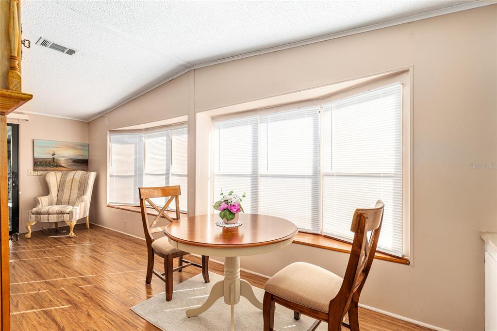 10085 Southeast 126th Place Belleview, FL 34420 - Photo 14 of 45 a view of a dining room with furniture window and outside view