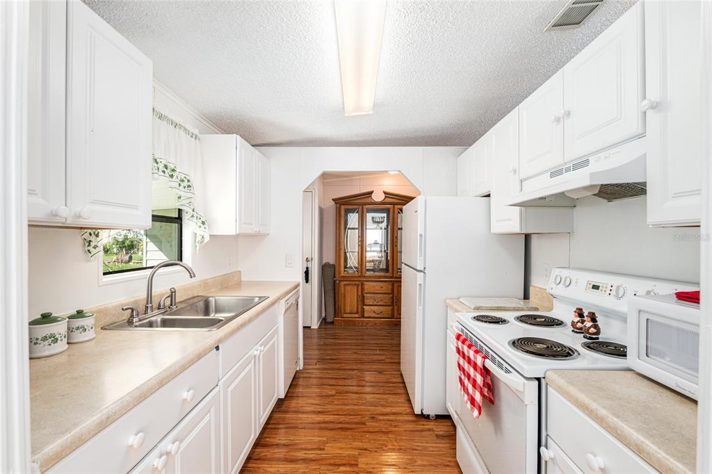 10085 Southeast 126th Place Belleview, FL 34420 - Photo 16 of 45 a kitchen with kitchen island a sink stove and cabinets